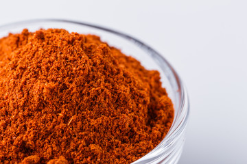 aromatic spicy chili powder on a white background