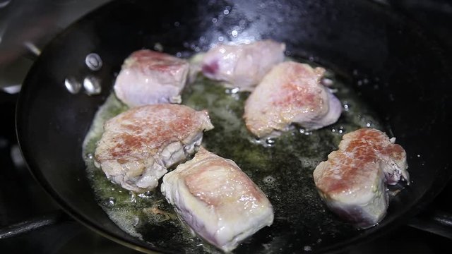 Cook chef cooking escalope steak on frying pan