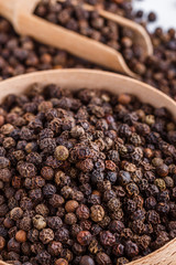 fragrant black pepper on white acrylic background