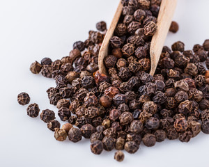fragrant black pepper on white acrylic background