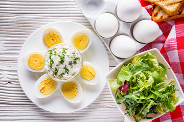 boiled chicken eggs on a white wooden rustic background