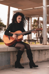 Brunette girl playing classical guitar
