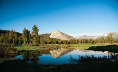 Foto op Canvas Landscape of Tuolumne Meadows and Lembert Dome with reflections in calm water, Yosemite National Park, California, USA © Anastassiya