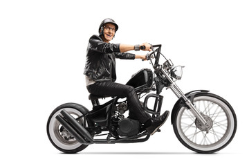 Obraz na płótnie Canvas Elderly man riding a customized chopper motorbike