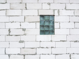 Fototapeta na wymiar A wall of white foam blocks with a window