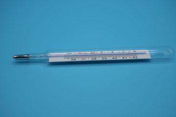 medical thermometer on blue background