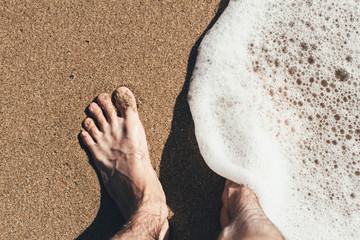Legs in the sea waves Sea beach Sea waves overlook the sandy shore