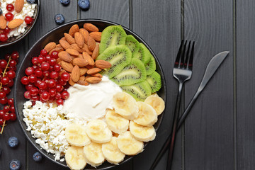 Bowl with tasty salad on dark wooden background