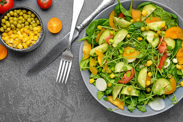 Bowl with tasty salad on dark background