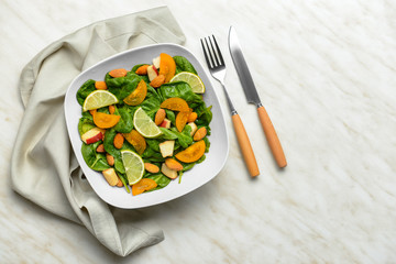 Bowl with tasty salad on white background