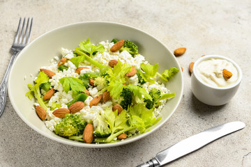 Bowl with tasty salad on grey background