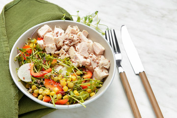 Bowl with tasty salad on white background