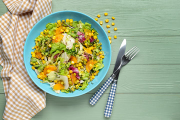 Bowl with tasty salad on table