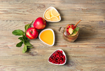 Mason jar of cold tea and ingredients on wooden table