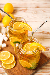 Mason jars of cold tea on wooden table