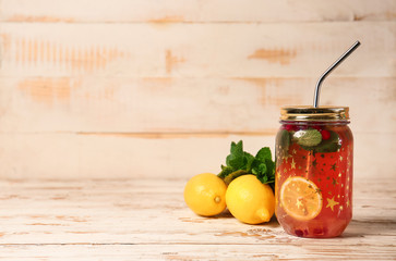 Mason jar of cold tea on wooden table