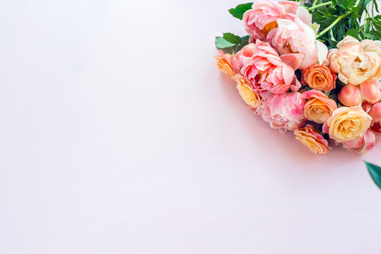 Fresh bunch of pink peonies and roses on pink background. Card Concept, pastel colors, close up image, copy space