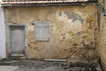 old derelict house with front door and closed window