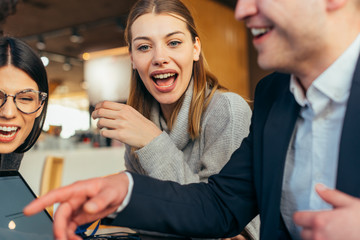 Group of young multiethnic friends bonding and having fun in a coffee shop