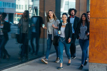 Group of colleagues on a business trip (euro trip) walking together at a modern  futuristic station