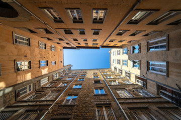 Traboule in Lyon. Original and symetrical shot of buildings and blue sky