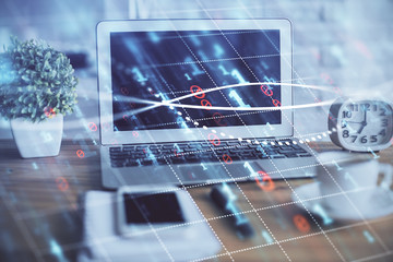 Stock market chart hologram drawn on personal computer background. Double exposure. Concept of investment.