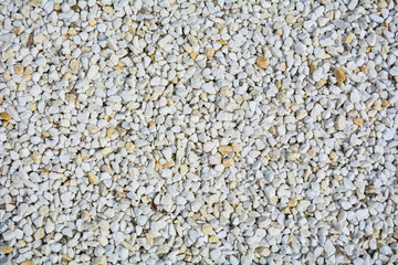 Small White and yellow pebble background. Top view of gravel stone texture