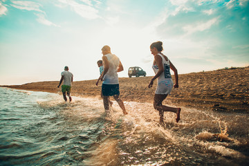 Fototapeta premium Happy smiling friends jogging at the beach