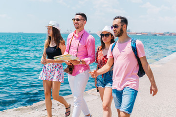 Tourists looking at a map and planning the places they are supposed to visit.