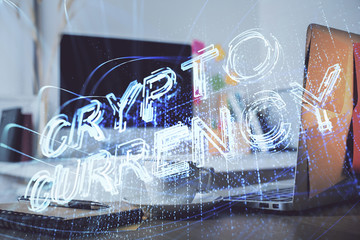 Multi exposure of blockchain and crypto economy theme hologram and table with computer background....
