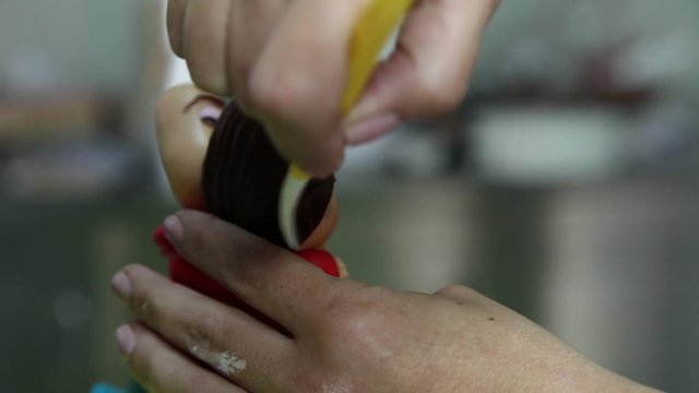 confectioner making figure from sugar paste fondant cake pastery
