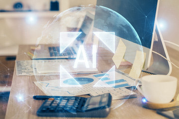 Double exposure of desktop computer and technology theme hologram. Concept of software development.