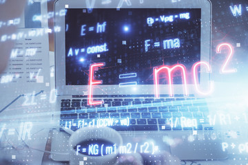Desktop computer background and formula hologram writing. Double exposure. Education concept.