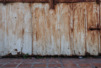 The old rusty metal fence background and footpath.