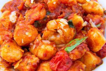Gnocchi with tomato sauce and garnshied basil and cheese