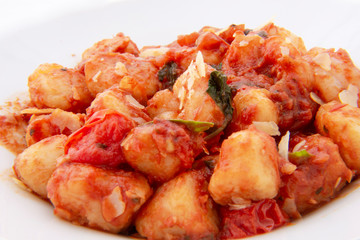 Gnocchi with tomato sauce and garnshied basil and cheese