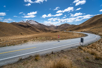 amazing view from lindis pass in new zealand. Highway crossing scenic landscape.mountains with snow on the background