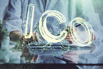 Cryptocurrency hologram, bitcoin, ico theme over hands taking notes background. Concept of blockchain. Multi exposure