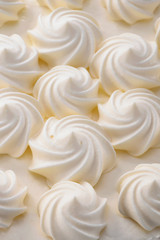 cream curls decoration on cake surface close-up creative food background