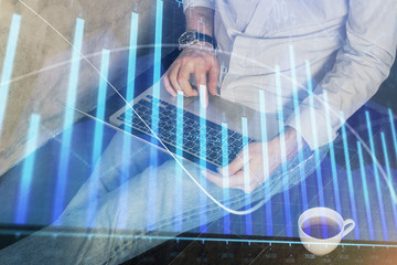 Forex graph with businessman working on computer in office on background. Concept of analysis....