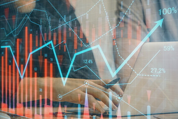 Forex graph with businessman typing on computer in office on background. Concept of analysis....