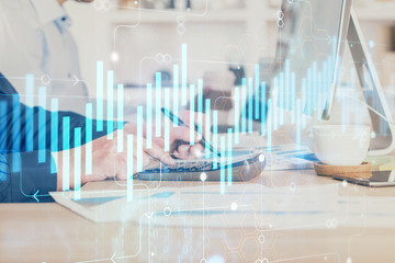 Forex graph with businessman working on computer in office on background. Concept of hardworking. Closeup. Multi exposure.
