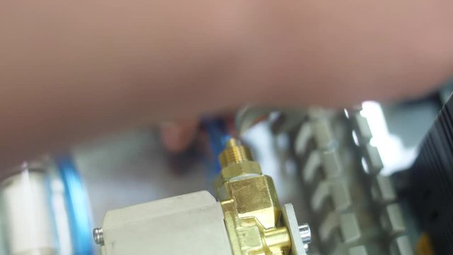 tighten brass nut with wrench in pneumatic automation system