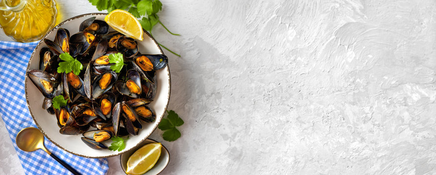 Delicious and healthy steamed mussels on white background