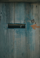 Wooden door with peeling paint and vintage handles with space for text