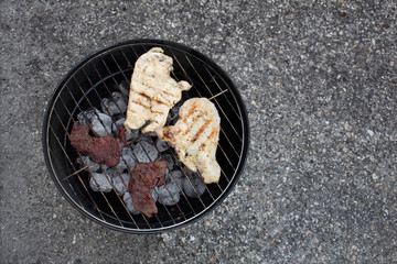 cooking barbecue meat and chicken outdoors