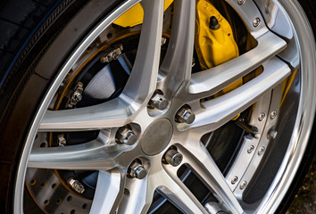 Automobile braking system. Ceramic carbon disk with perforation, ventilation and black calipers.