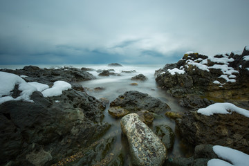 long exposure of rocky and seascape at sunset