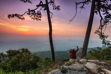Young girl traveling   on the high mountain at Phu-kra-dueng national park Loei province, Thailand.
