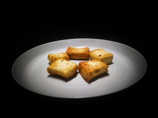 A plate of fish cake isolated on black background